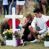 Santa Fe, USA. Fassungslos kniet ein Paar vor zwei Holzkreuzen auf dem Gelände der Santa Fe High School. Ein Amokläufer war drei Tage zuvor zu Unterrichtsbeginn mit einem Sturmgewehr und einem Revolver in seine Schule gekommen und hatte dort um sich geschossen. Bei dem Blutbad wurden zehn Menschen getötet und 13 weitere verletzt.