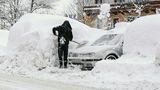 Österreich, Saalbach. Ein Mann schaufelt sein Auto auf einem Parkplatz frei. Immer mehr Touristen sitzen fest. Wie schon am Mittwoch sind die beliebten Reiseziele Obertauern, Lech, Zürs und Hallstatt weiter nicht zu erreichen.