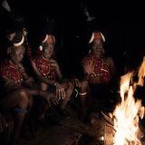 Männliche Stammesmitglieder der Konyak sitzen um eine offene Feuerstelle