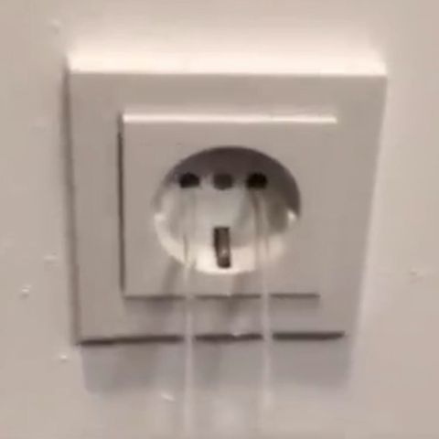 Aus einer Steckdose fließt Wasser, eine gefährliche Kombination. 
