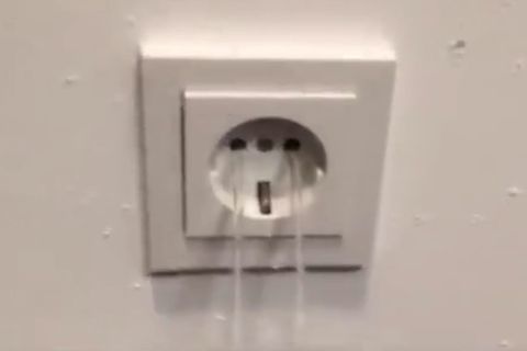 Aus einer Steckdose fließt Wasser, eine gefährliche Kombination. 