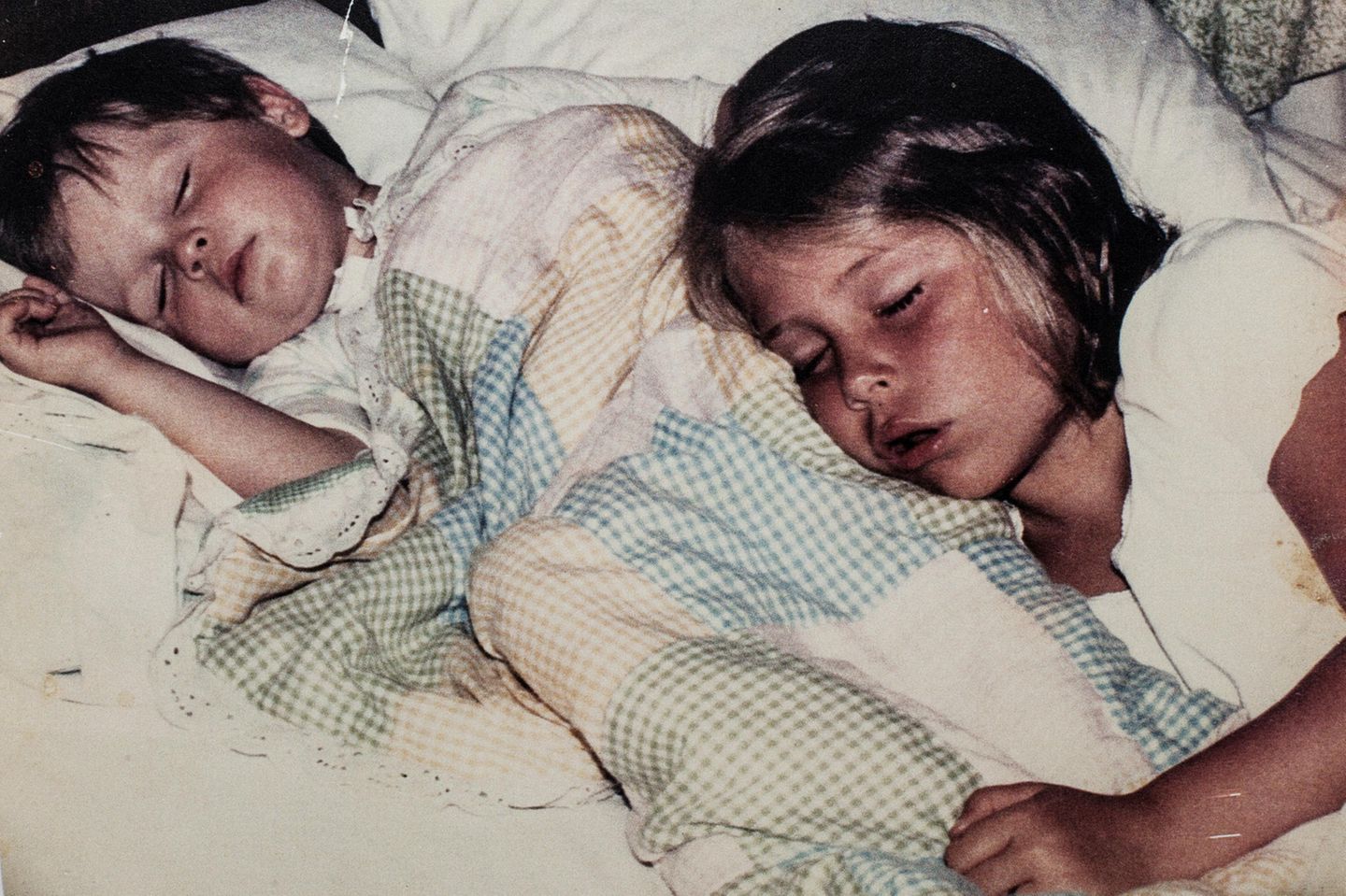 Zwei kleine Kinder schlafen in einem Bett