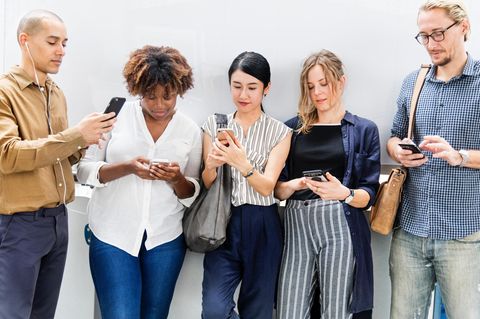 Fünf Menschen schauen auf ihr Smartphone