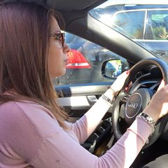 Eine junge Frau sitzt am Steuer