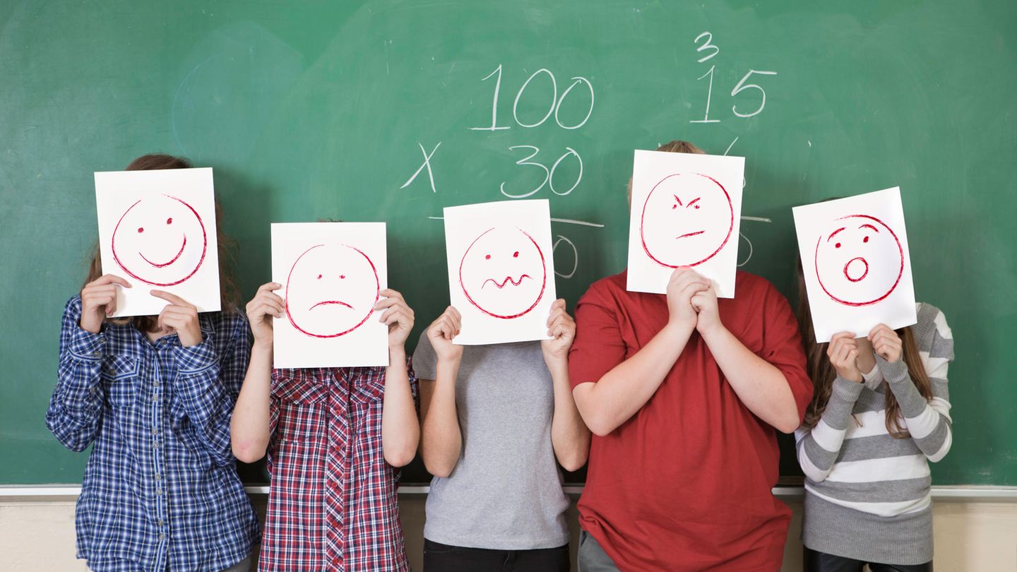 Schule stehen mit Smileys vor der Tafel