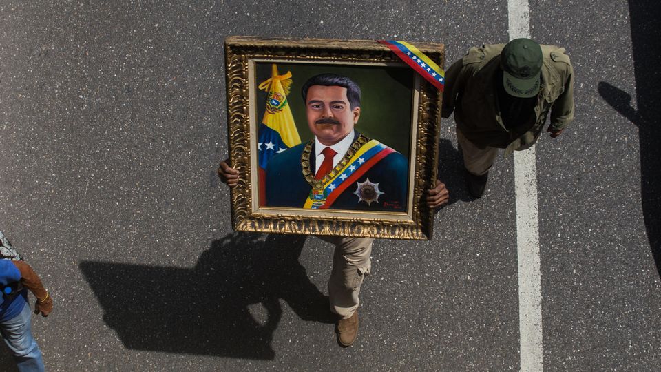 Ein Soldat in Venezuela trägt am 1. Mai ein Bild des Staatspräsidenten Nicolás Maduro