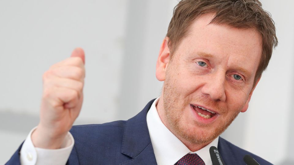 Michael Kretschmer, CDU-Ministerpräsident von Sachsen, gestikuliert und spricht in ein Mikrofon