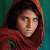 Peschawar (Pakistan), 1984. Das wohl bekannteste Bild von McCurry zeigt Sharbat Gula, in der Welt der Fotografie besser bekannt als "Afghan Girl" (so der Titel der Arbeit). Sharbat Gula wurde um 1972 geboren und durch die Bombardierungen der sowjetischen Armee in Afghanistan zur Vollwaise. In einem Flüchtlingscamp in Pakistan wurde McCurry auf das Mädchen aufmerksam. Er fertigte zwei Porträts des Mädchens an. Das weitaus bekanntere, das zu sehende Bild, wurde 1985 auf der Titelseite von "National Geographic" abgedruckt. Seitdem wurde es millionenfach auf Postern und Buchcovern weltweit gedruckt.