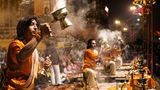 Indien / Feuerlicht  Zu Beginn ertönt ein Muschelhorn am Fluss Ganges in Varanasi. Dann beginnen die jungen Priester zu Zimbelklängen Feuerlampen zu schwenken. Das Aarti-Ritual wird von gläubigen Hindus täglich abgehalten. Es soll in der Konzentration auf die Elemente und Bewegung den Menschen näher zu Gott bringen. Und Gott näher an die Menschen.