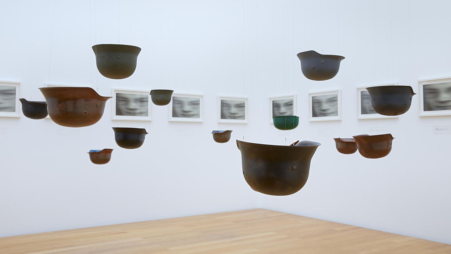 Yoko Ono – "Peace is Power" Militärhelme hängen von der Decke