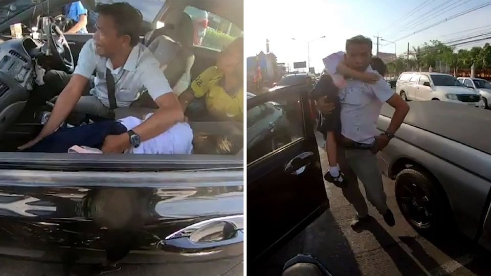 Vater trägt seine kranke Tochter durch Stau in Thailand Vater trägt seine kranke Tochter durch Stau in Thailand