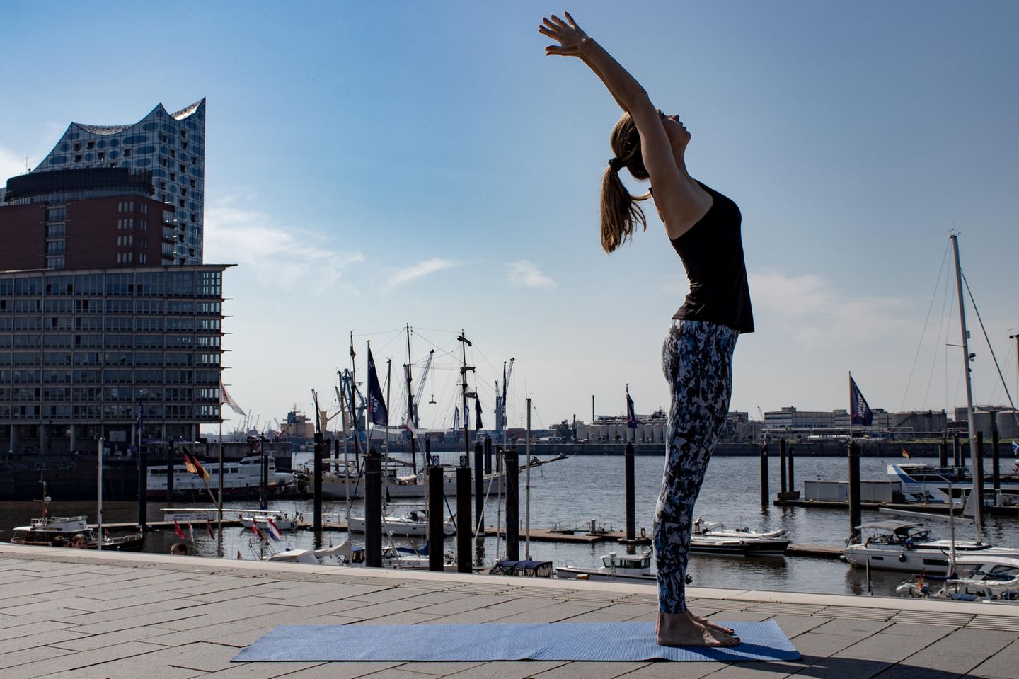 Frau in Sportklamotten beim Yoga.
