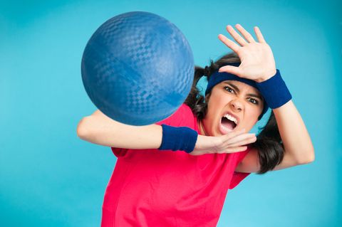 Eine Frau wird beim Völkerball von einem Ball getroffen