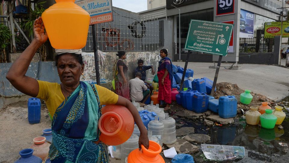 Einwohner in Chennai versuchen, an einer Ausgabestelle noch Wasser abzuzapfen. Die meisten Wasserhähne der Stadt sind bereits ausgetrocknet. Einwohner in Chennai versuchen, an einer Ausgabestelle noch Wasser abzuzapfen. Die meisten Wasserhähne der Stadt sind bereits ausgetrocknet.