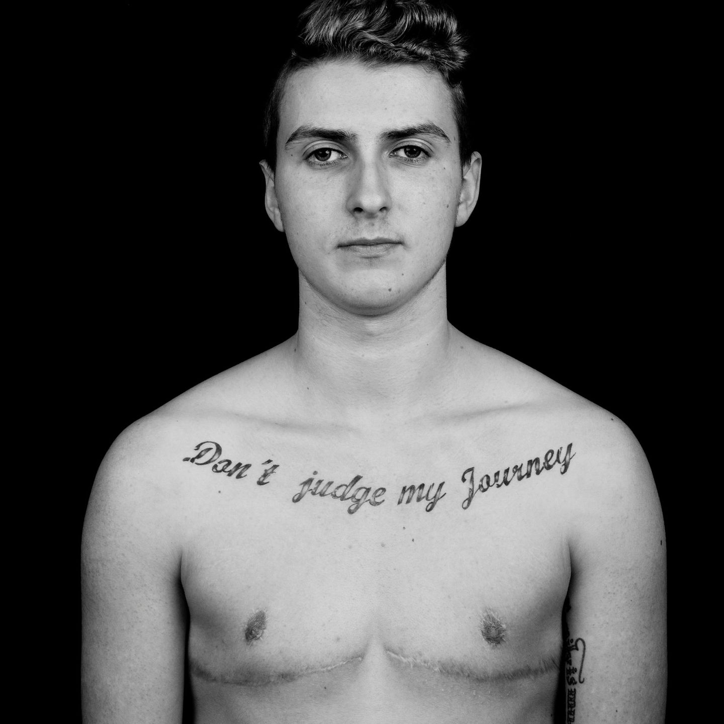 Transgender Ein Transmann mit Tattoo auf der Brust