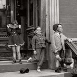 Drei maskierte Kinder, die sich auf ihren Halloween-Umzug vorbereiten