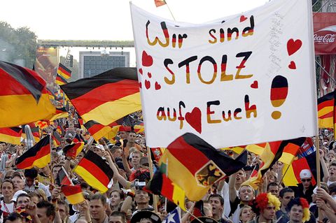 Deutsche Fans mit Fahnen jubeln auf einem Fanfest bei der Fußball-WM 2006