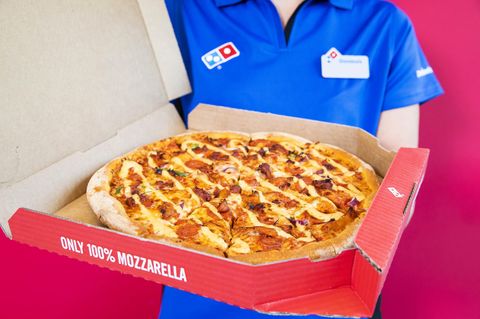Ein Domino's-Mitarbeiter hält eine Pizza in der Hand. Der Brexit könnte zu Lieferengpässen führen.