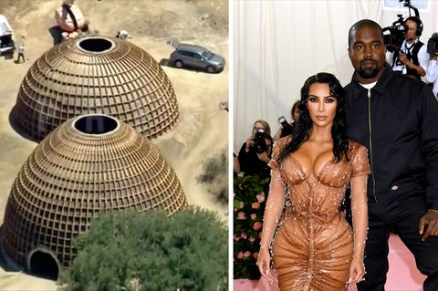 Kanye West und seine Frau Kim Kardashian posieren bei einem Event für Fotografen. Links stehen halbkugelförmige Häuser
