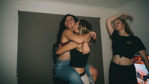 Freundinnen tanzen im Wohnzimmer