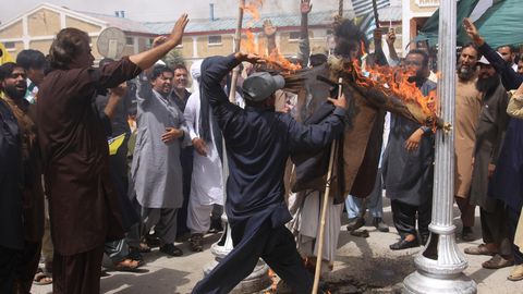 Ein Mann schlägt in der pakistanischen Stadt Quetta, auf ein brennendes Bild des indischen Premierministers Modi ein