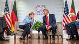 Bundeskanzlerin Angela Merkel und US-Präsident Trump tuscheln