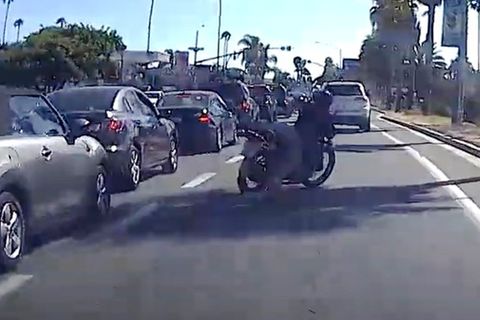 Motorradfahrer auf einer befahrenen Straße