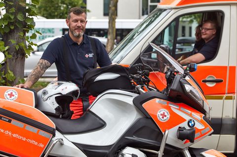Biker und Retter  Das Ehrenamt für Biker: Motorrad fahren für die gute Sache beim Deutschen Roten Kreuz. So wie Henry Markowski. Neben seinem Vollzeitjob engagiert sich der begeisterte Biker bei der DRK-Zweiradstaffel und absolviert dort gerade die Ausbildung zum Rettungssanitäter.   Wer also von seinem eigenen Zweirad auf eine der speziell ausgerüsteten BMW umsteigen und zudem noch eine fundierte Sanitätsausbildung genießen möchte  - hier ist die Gelegenheit. Die ehrenamtlichen DRK-Biker werden als sogenannte First Responder eingesetzt, die noch vor den eigentlichen Rettungskräften eintreffen und die Erstversorgung sicherstellen. Die Motorradstaffeln sind vergleichsweise dünn gesät. In Hamburg und Gelsenkirchen, Herten bei Recklinghausen gibt es Kradstaffeln sowie in Augsburg-Land, Rodgau, Contwig bei Saarbrücken oder Borken (NRW).