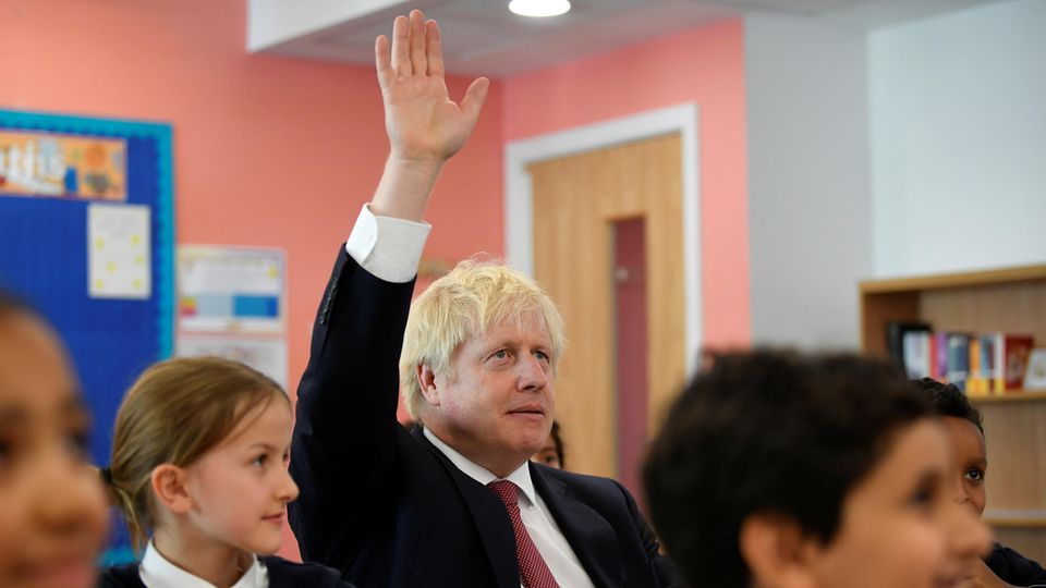 Boris Johnson, Premierminister von Großbritannien, hebt seinen Arm in einer Schulklasse