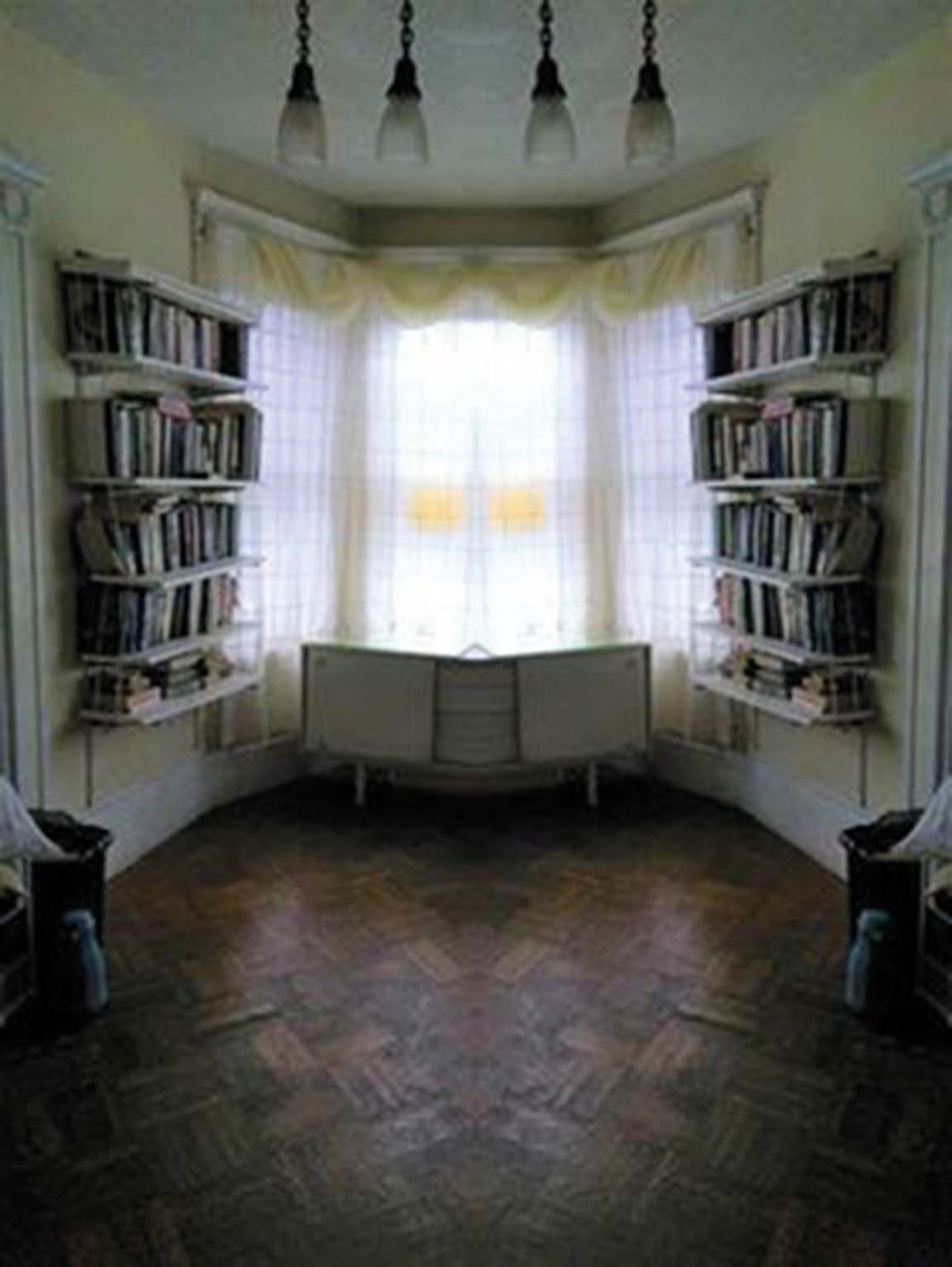 Warum ist das Bild in der Mitte gespiegelt, sodass sich das Zimmer um das Sideboard krümmt? Gruselig.