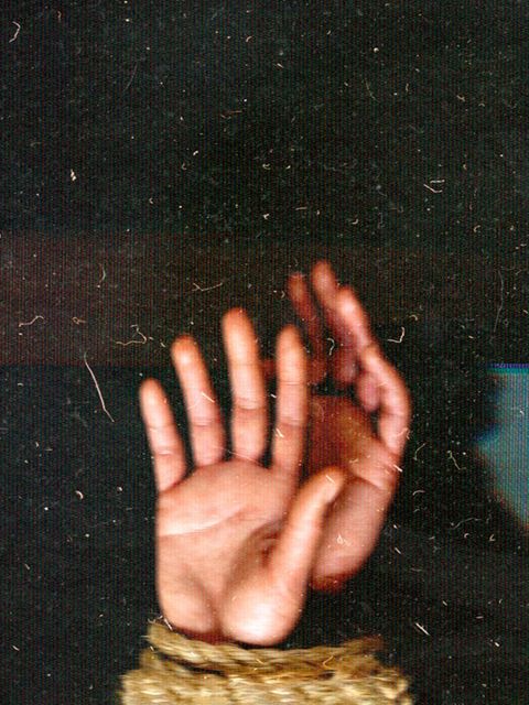 Mit einem Seil gefesselte Hände