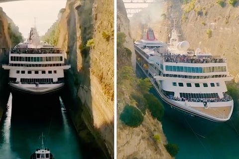 Ein Kreuzfahrtschiff fährt durch einen sehr engen Kanal mit behauenen Felswänden