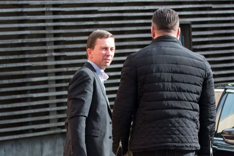 Bernd Lucke steht auf dem Parkplatz neben einem Auto
