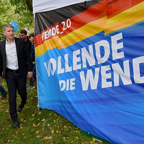 Neben einem blauen Tuch mit dem Slogan "Vollende die Wende" steht AfD-Spitzenkandidat Björn Höcke