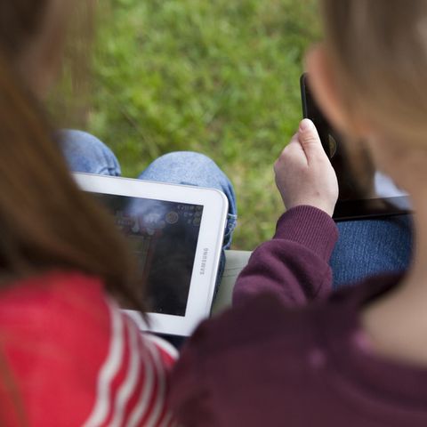 Zwei kleine Mädchen schauen auf ihre Tablet-Computer