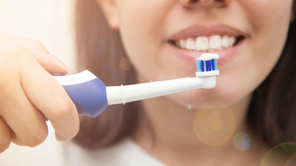 Elektrische Zahnbürste Stiftung Warentest: Eine Frau putzt Zähne