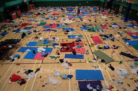 Schlafmatten, Müll und Kleidung liegen in einer Sporthalle der besetzten Hochschule