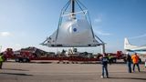 Ein Kran hievt das Raumfahrzeug der Nasa, das in Zusammenarbeit mit der European Space Agency (ESA) gebaut wird, auf einen Sattelschlepper.