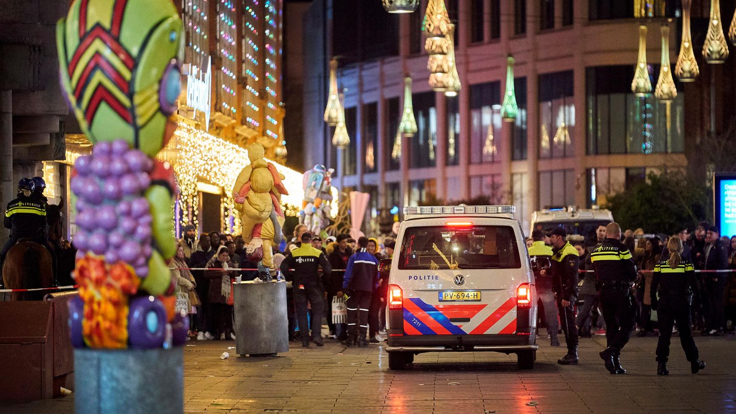 Niederlande, Den Haag: Polizisten stehen in einer Einkaufsstraße.