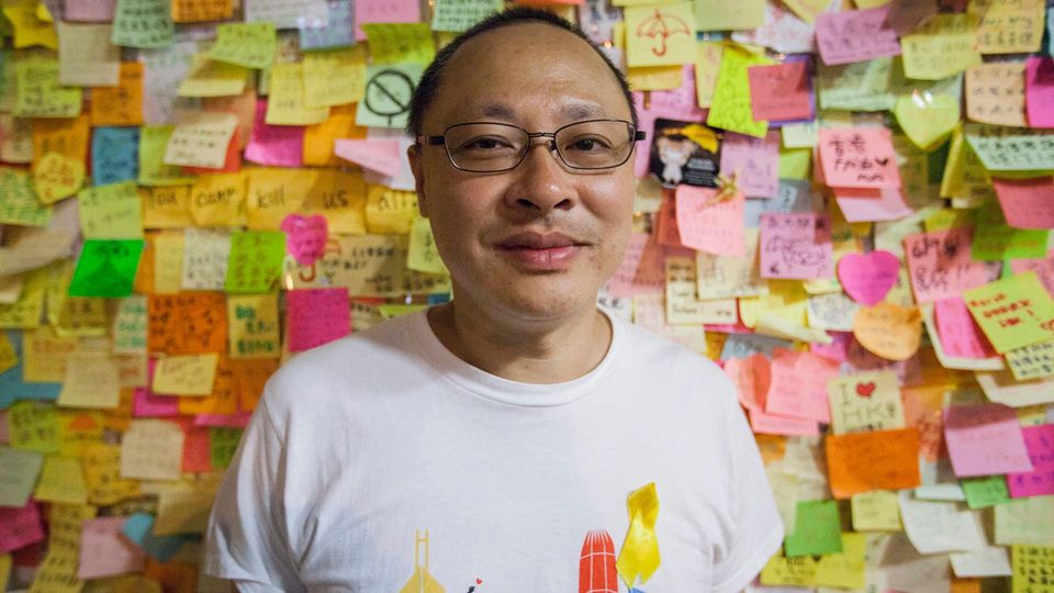 Benny Tai posiert für das Foto vor de "Democray Wall" (Demokratie-Wand) im Regierungsgebäude von Hongkong