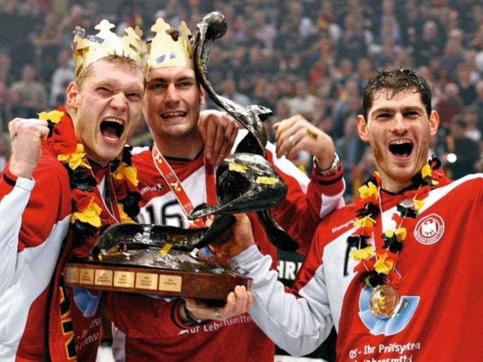 04 Feb 2007, COLOGNE, Germany --- (L-R) The three goalkeepers Johannes Bitter, Carsten Lichtlein and Henning Fritz hold the Handball World Cup trophy after winning their final match against Poland in Cologne, Germany. --- Image by © Ina Fassbender/Reute... Henning F