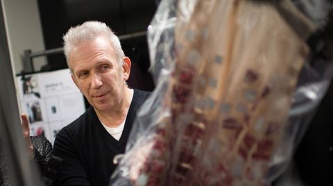 Jean Paul Gaultier mit einem Kleid nach seinen Entwürfen