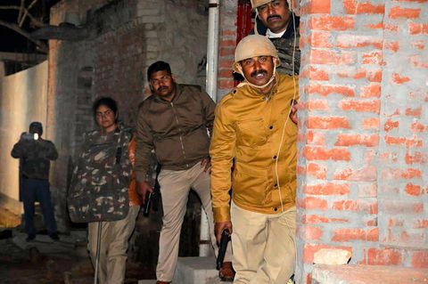 Indien, Kasaria Village: Polizeibeamte gehen während der Mission zur Befreiung von Geiseln in Deckung