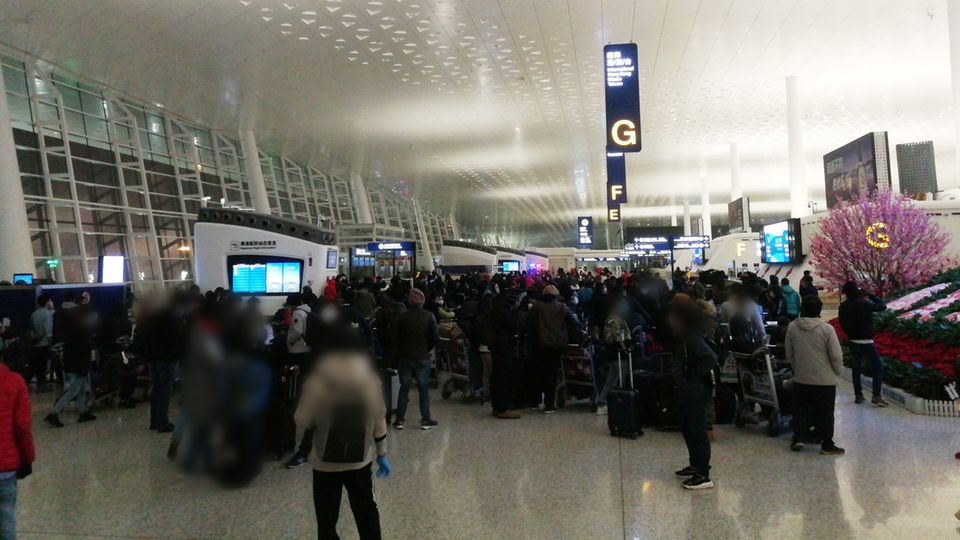 Menschen warten am Flughafen Wuhan