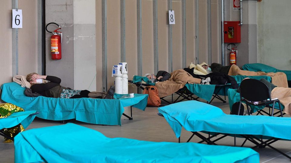 So wie hier im lombardischen Brescia müssen viele Patienten auf Behelfsbetten in Not-Sälen behandelt werden.