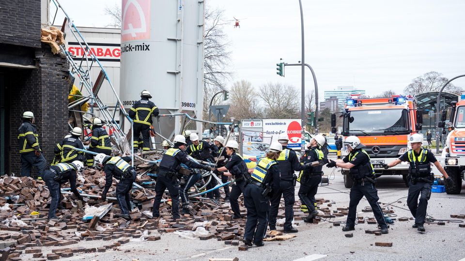 Nachrichten aus Deutschland: Baugerüst samt Fassade eingestürzt - mehrere Menschen verletzt Nachrichten aus Deutschland: Feuerwehrleute sichern den Unglücksort am Millerntorplatz