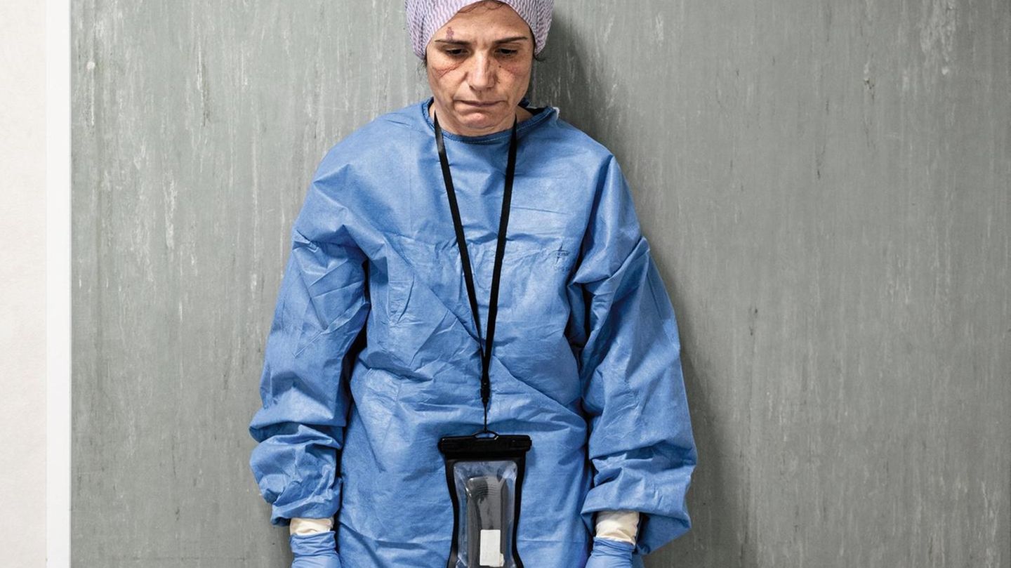 DOCTORS AND NURSES OF THE INTENSIVE CARE HOSPITAL, FIGHTING COVID-19 EMERGENCY IN PESARO - ITALY. THEY ARE PORTRAITED AT THE END OF THEIR LONG WORKSHIFT. 12 HOURS WITH NO DRINK AND NO TOILETBREAK, DUE TO THE PROTECTIVE SUIT THEY WEAR. THE SIGNS ON THEIR... Margherita Lambertini