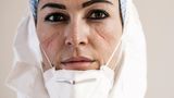DOCTORS AND NURSES OF THE INTENSIVE CARE HOSPITAL, FIGHTING COVID-19 EMERGENCY IN PESARO - ITALY. THEY ARE PORTRAITED AT THE END OF THEIR LONG WORKSHIFT. 12 HOURS WITH NO DRINK AND NO TOILETBREAK, DUE TO THE PROTECTIVE SUIT THEY WEAR. THE SIGNS ON THEIR... Francesca Palumbo