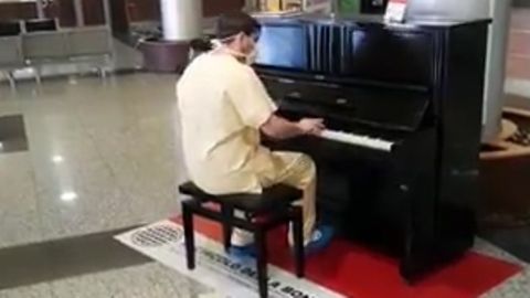 Ein italienischer Arzt spielt Klavier in der leeren Empfangshalle seines Krankenhauses.