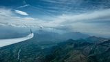 Wellenreiten in der Luft  In den französische Alpen über dem Chabottes Tal. Die längliche Wolke rechts ist ein Zeichen für eine sogenannte Welle, der Traum der Segelflieger. Wellen können bei kräftigem Wind entstehen, wenn die Luftmasse hinter einem Berg mit viel Energie ins Tal hinabstömt und dann in Schwingungen gerät. Diese auf- und ab Bewegungen setzen sich mitunter bis in große Höhen fort. Da die Luft in einer Welle sehr ruhig ist, fliegt ein Segelflugzeug dort so stabil wie ein Airliner.  Höhen von über 4000 Metern sind keine Seltenheit. Der Weltrekord liegt bei 14.000 Metern. Die Position des Flugzeugs auf Google Earth.